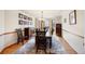 Formal dining room featuring a decorative rug, wood floors, and a bay window that provides lots of natural light at 50 Deerwood Dr, Littleton, CO 80127