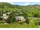 Areal rear view of a residence featuring a deck, manicured lawn, and a fence at 50 Deerwood Dr, Littleton, CO 80127