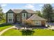 Charming two-story home featuring a beautifully landscaped front yard, inviting walkway, and an arched entryway at 50 Deerwood Dr, Littleton, CO 80127