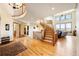 Open foyer featuring a dramatic staircase, gleaming hardwood floors, and abundant natural light at 50 Deerwood Dr, Littleton, CO 80127