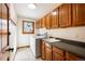 Laundry room with abundant storage, a utility sink, and a window that provides natural light at 50 Deerwood Dr, Littleton, CO 80127