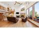 Inviting living room featuring a fireplace, soaring ceilings, hardwood floors, and a staircase at 50 Deerwood Dr, Littleton, CO 80127