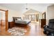 Spacious main bedroom with hardwood floors, a bay window, and a ceiling fan for added comfort at 50 Deerwood Dr, Littleton, CO 80127