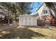 Backyard shed for extra storage with double doors on a sunny day at 50 Deerwood Dr, Littleton, CO 80127