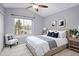 Inviting bedroom filled with natural light, neutral decor, and a window offering views of the outdoors at 1885 S Quebec Way # M101, Denver, CO 80231