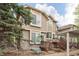 Charming home with a brick and wood facade, complemented by lush landscaping at 1885 S Quebec Way # M101, Denver, CO 80231