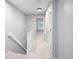 Bright hallway with carpeted floors, doors, and white railings leading to a staircase, blending style and functionality at 1885 S Quebec Way # M101, Denver, CO 80231