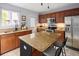 Spacious kitchen with stainless steel appliances, granite countertops, and a functional center island at 1885 S Quebec Way # M101, Denver, CO 80231