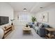 Inviting living room with a blue sofa, TV, neutral decor, and plenty of natural light at 1885 S Quebec Way # M101, Denver, CO 80231