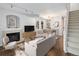 Inviting living room featuring a fireplace, wood floors, and dining area for seamless entertaining at 1885 S Quebec Way # M101, Denver, CO 80231