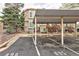 Exterior parking spot showing the covered parking, stairs to the unit, and trees around the property at 1885 S Quebec Way # M101, Denver, CO 80231