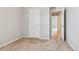 Cozy bedroom featuring plush carpet, neutral paint, and doorway to hall at 6491 N Danube St, Denver, CO 80249