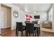 Dining space with table, views to living room, and natural light at 6491 N Danube St, Denver, CO 80249