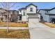 Charming two-story home featuring a well-maintained front yard and a two-car garage at 6491 N Danube St, Denver, CO 80249