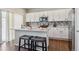 Beautiful kitchen with white cabinets, island with bar stools, and stainless appliances at 6491 N Danube St, Denver, CO 80249