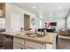 Open concept kitchen with stainless steel sink, modern faucet and view of dining and living area at 6491 N Danube St, Denver, CO 80249