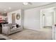 Spacious living room with neutral carpet, gray sofa set, and views of dining area at 6491 N Danube St, Denver, CO 80249