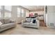 Bright living room with neutral decor, an open floor plan, and views to the kitchen at 6491 N Danube St, Denver, CO 80249