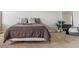 Comfortable main bedroom featuring plush bedding and a full-length mirror, creating a cozy retreat at 6491 N Danube St, Denver, CO 80249