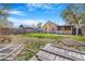 Spacious backyard with grass, wooden fence, porch, and shed potential for outdoor activities at 540 Hickory St, Hudson, CO 80642