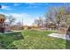 Large backyard with grass and mature trees at 540 Hickory St, Hudson, CO 80642