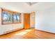 Bedroom with wood-style floors and bright natural light at 540 Hickory St, Hudson, CO 80642
