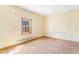 Cozy bedroom features carpet, neutral paint, and small window at 540 Hickory St, Hudson, CO 80642