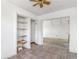 Hallway leading into living room, features built-in shelves and patterned flooring at 540 Hickory St, Hudson, CO 80642