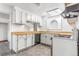 Functional kitchen featuring white cabinets, butcher block countertops, and modern appliances at 540 Hickory St, Hudson, CO 80642