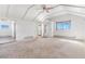 Bright living room with vaulted ceilings, neutral carpet and natural light through a large window at 540 Hickory St, Hudson, CO 80642