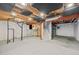 Unfinished basement with soundproofing, exposed pipes and beams, and potential for customization at 18121 E Adriatic, Aurora, CO 80013