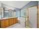 Light-filled bathroom features a double vanity, soaking tub, and glass-enclosed shower stall at 18121 E Adriatic, Aurora, CO 80013