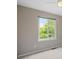 Bright bedroom with a large window overlooking mature trees at 18121 E Adriatic, Aurora, CO 80013