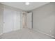 Neutral bedroom with closet, open doorway, carpet flooring and base trim at 18121 E Adriatic, Aurora, CO 80013