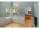 Bright dining area with hardwood floors, large windows, and an open view into the adjacent kitchen at 18121 E Adriatic, Aurora, CO 80013