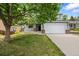 Charming two-story home featuring a well-manicured lawn, mature trees, and an attached two-car garage at 18121 E Adriatic, Aurora, CO 80013
