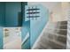 Bright hallway with stairs and a display shelving unit featuring accent blue paint at 18121 E Adriatic, Aurora, CO 80013