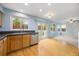 Well-lit kitchen featuring hardwood floors, modern appliances, and a sliding glass door leading to the outside at 18121 E Adriatic, Aurora, CO 80013
