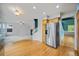 Spacious kitchen with stainless steel refrigerator, hardwood floors, and an open layout at 18121 E Adriatic, Aurora, CO 80013