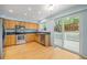 Bright kitchen with stainless steel appliances, wood cabinets, and a sliding door that leads to the deck at 18121 E Adriatic, Aurora, CO 80013