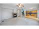 Open-concept living room featuring a fireplace and seamless transition to the kitchen at 18121 E Adriatic, Aurora, CO 80013