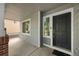 Close-up of a home's front porch, featuring a black front door and a large window at 18121 E Adriatic, Aurora, CO 80013
