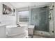 Bright bathroom featuring a soaking tub and a walk-in shower with glass enclosure at 5207 Denim Ct, Parker, CO 80134