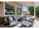 Inviting covered patio with stylish seating, a dog house, and serene views at 5207 Denim Ct, Parker, CO 80134