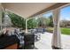 Relaxing covered patio featuring comfortable seating and backyard view at 5207 Denim Ct, Parker, CO 80134