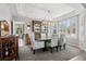 Formal dining room featuring a modern chandelier, bay windows, and elegant furnishings at 5207 Denim Ct, Parker, CO 80134