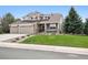 Charming two-story home with landscaped front yard, stone accents, and a welcoming porch at 5207 Denim Ct, Parker, CO 80134