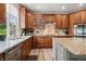 Bright kitchen with stainless steel appliances, granite counters, and ample cabinet space at 5207 Denim Ct, Parker, CO 80134