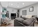 Comfortable living room with a plush gray couch, rocker, and built-in shelving for storage at 5207 Denim Ct, Parker, CO 80134