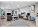 Bright living room with a comfortable couch and workspace with natural light from large windows at 5207 Denim Ct, Parker, CO 80134